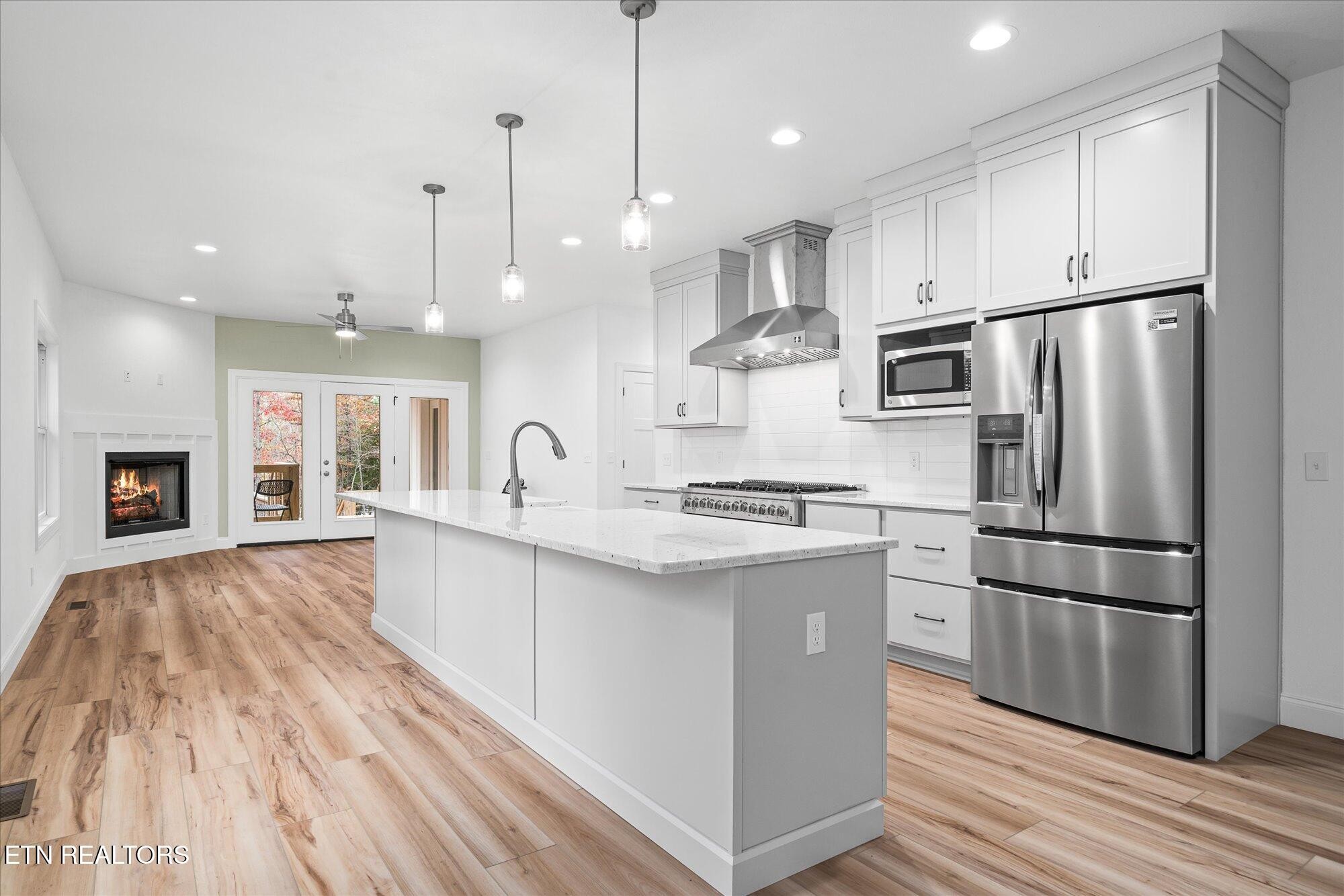565 Grassland Road Crossville, TN 38572 - Photo 8 of 53 a kitchen with kitchen island white cabinets and stainless steel appliances