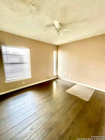 a view of room and hall with wooden floor