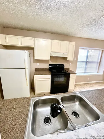 a kitchen with a sink and a stove