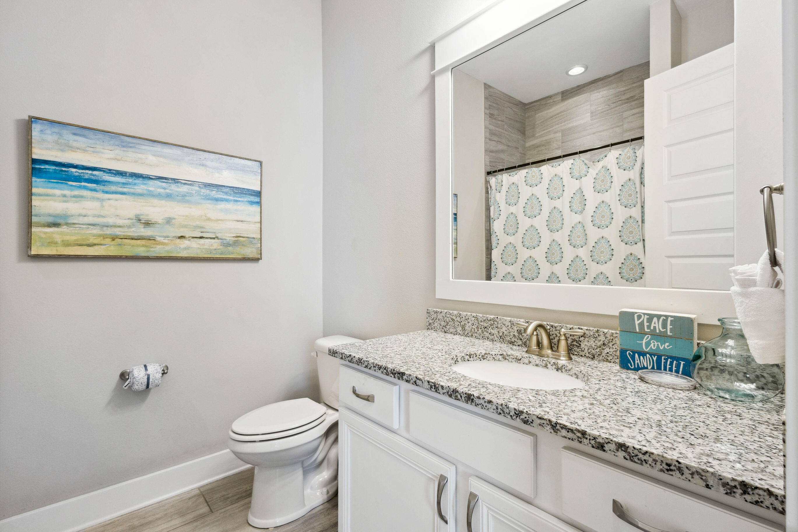 12 Milestone Dr Inlet Beach, Unit A Inlet Beach, FL 32461 - Photo 20 of 38 a bathroom with a granite countertop sink mirror vanity and toilet