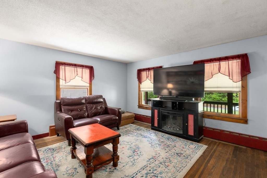 24 Webber Road Brookfield, MA 01506 - Photo 12 of 27 a living room with furniture and a flat screen tv