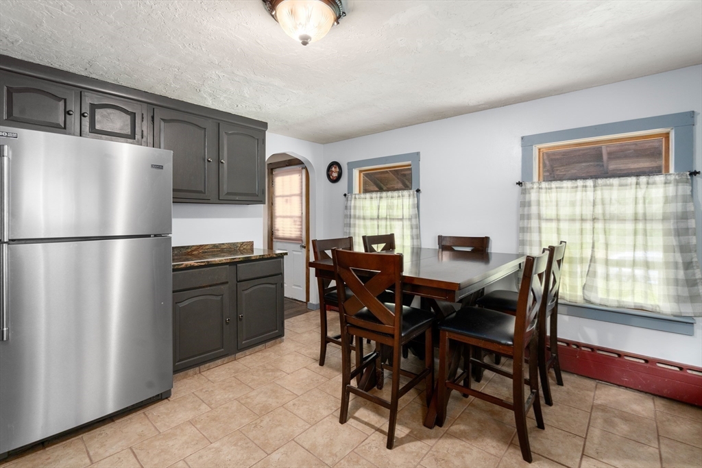 24 Webber Road Brookfield, MA 01506 - Photo 8 of 27 a kitchen with a refrigerator a table and chairs