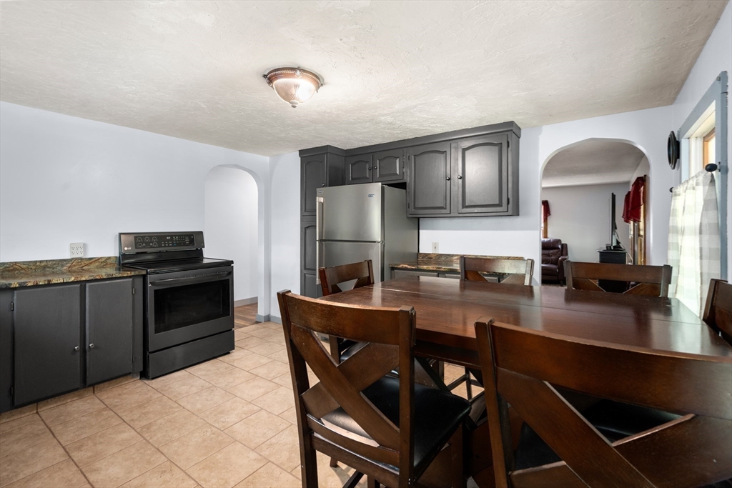 24 Webber Road Brookfield, MA 01506 - Photo 9 of 27 a kitchen with stainless steel appliances a stove a sink dishwasher a refrigerator and cabinets with wooden floor