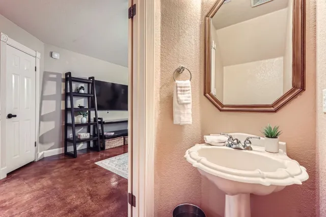a bathroom with a sink a mirror and a shower