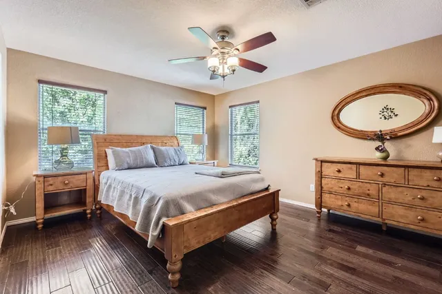 a bedroom with a bed dresser and a window