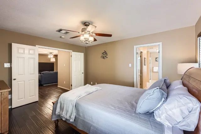 a bedroom with a large bed and a chandelier