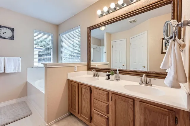 a bathroom with a sink double vanity and mirror