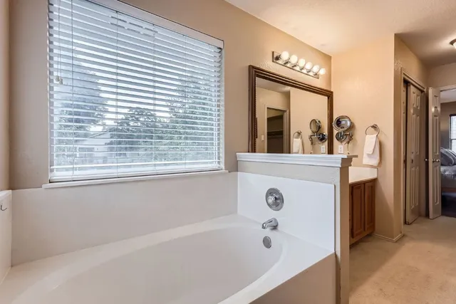 a bathroom with a bathtub and a window