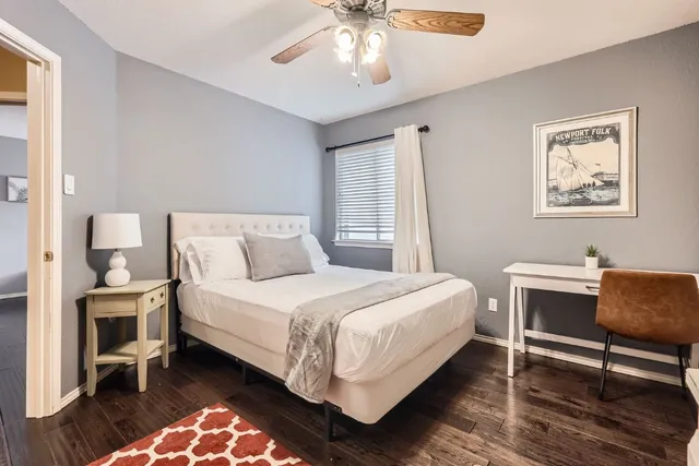 a bedroom with a bed and a chandelier