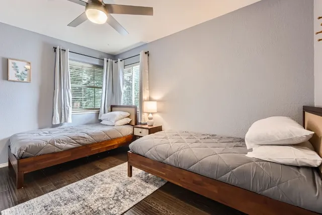 a bedroom with two beds and a chandelier