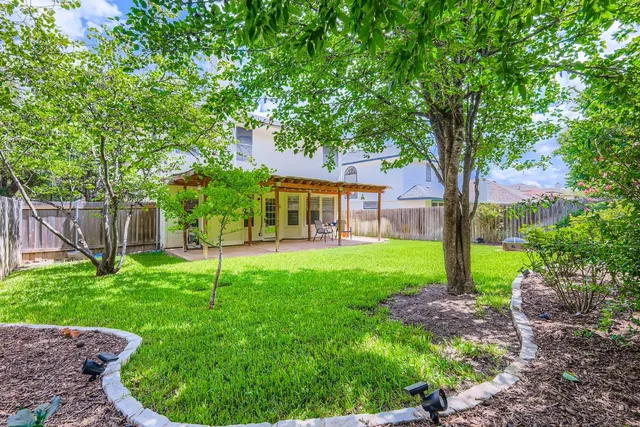 a view of a house with a backyard