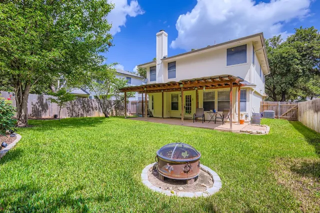 a front view of a house with a yard table and chairs
