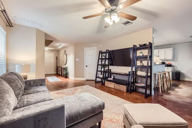 a bedroom with furniture and a wooden floor