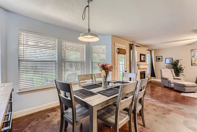 a view of a dining room with furniture wooden floor and chandelier
