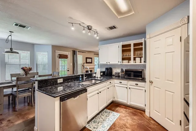 a kitchen with a sink stove and cabinets