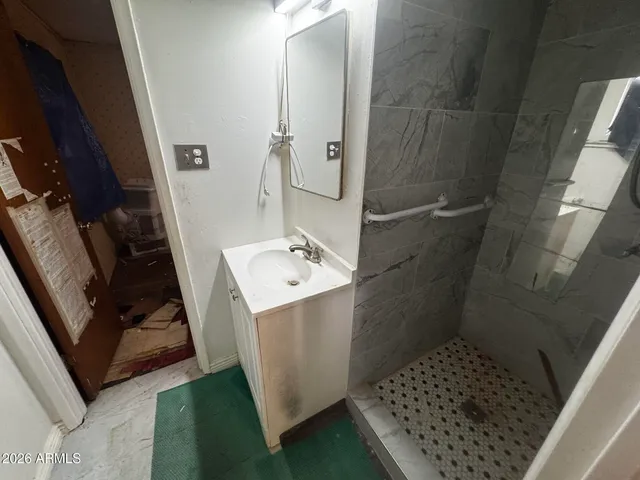 a bedroom with a bed and a mirror