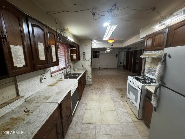a large kitchen with a large counter top appliances and cabinets