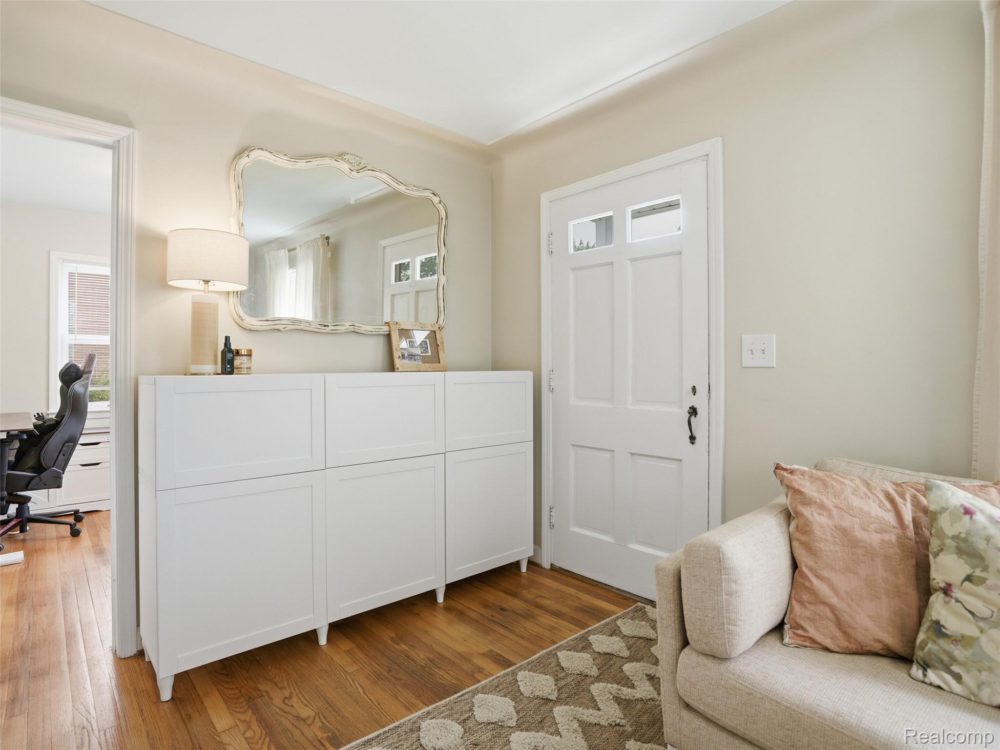 320 South Avery Road Waterford, MI 48328 - Photo 24 of 25 Entryway featuring wood-finish flooring, a white paneled door with glass inserts, and a white storage console