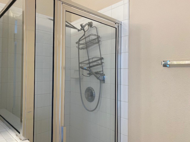 6519 Greenhouse Road Katy, TX 77449 - Photo 12 of 15 a bathroom with a glass shower door