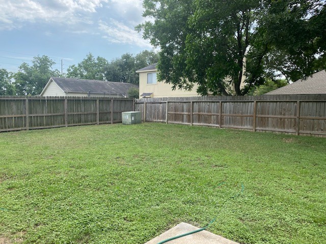 6519 Greenhouse Road Katy, TX 77449 - Photo 13 of 15 a view of a yard with a small cabin and a chair