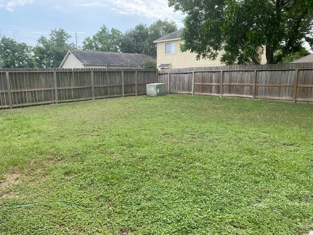 a view of a backyard with a cabin and wooden fence