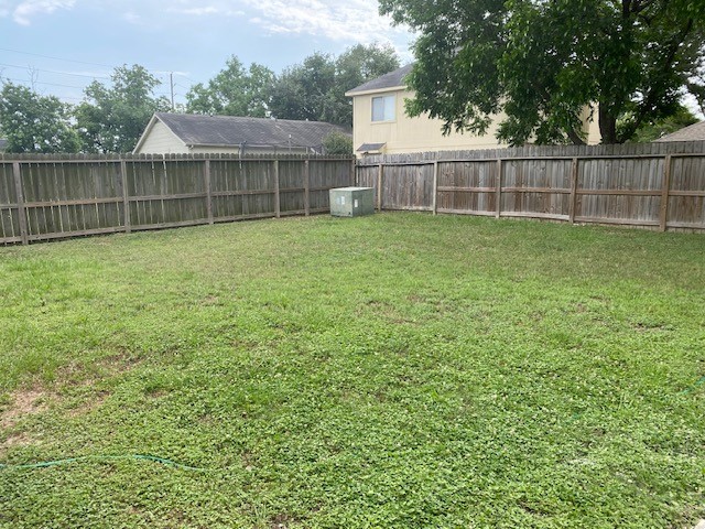 6519 Greenhouse Road Katy, TX 77449 - Photo 15 of 15 a view of a backyard with a cabin and wooden fence