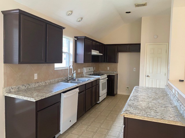 6519 Greenhouse Road Katy, TX 77449 - Photo 6 of 15 a kitchen with kitchen island granite countertop a sink stove and refrigerator