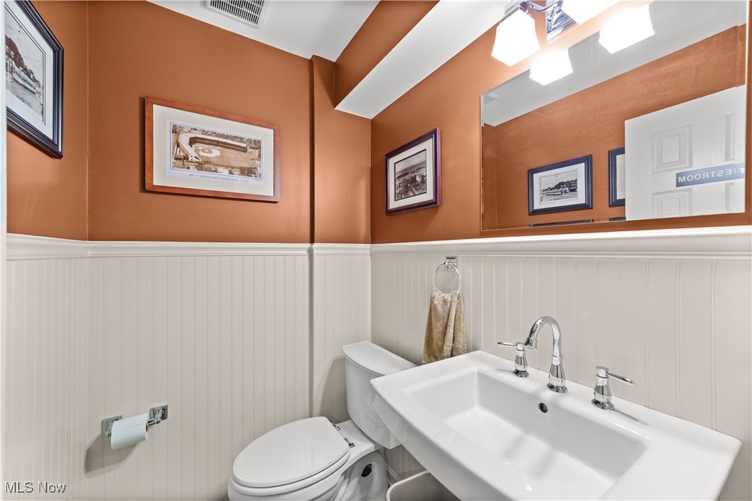 4500 Brooks Road Cleveland, OH 44105 - Photo 34 of 50 Basement-level half bathroom featuring toilet and wainscoting