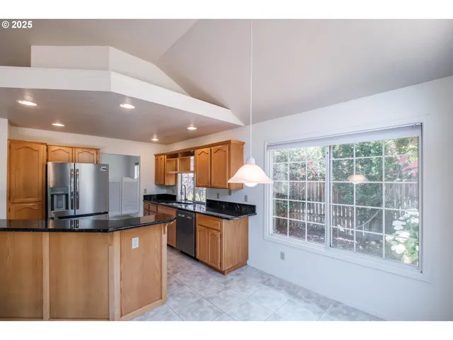 a kitchen with stainless steel appliances granite countertop a stove and a refrigerator