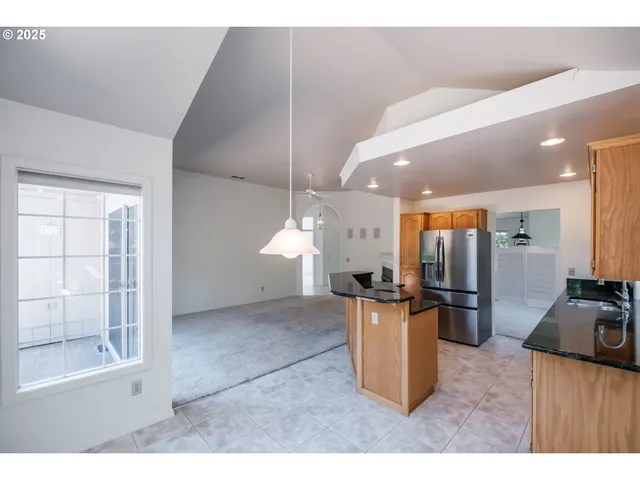 a open kitchen with refrigerator stove and microwave