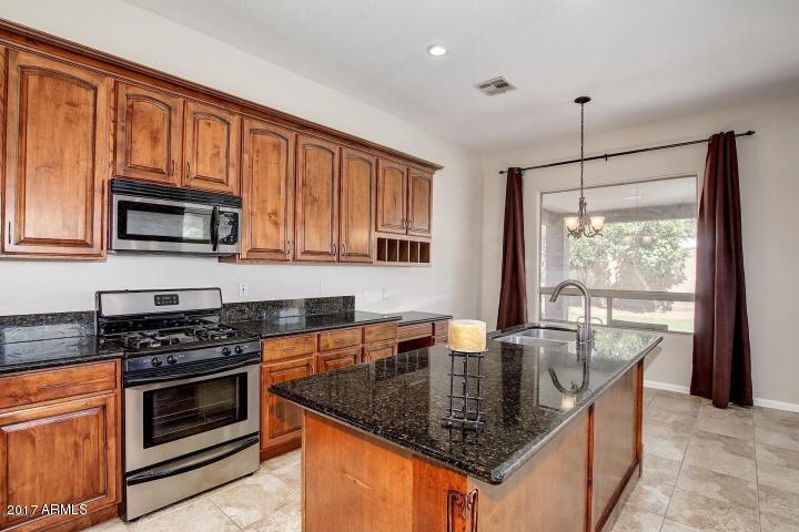 16810 North 62nd Place Scottsdale, AZ 85254 - Photo 10 of 31 a kitchen with stainless steel appliances granite countertop a stove a sink and a microwave