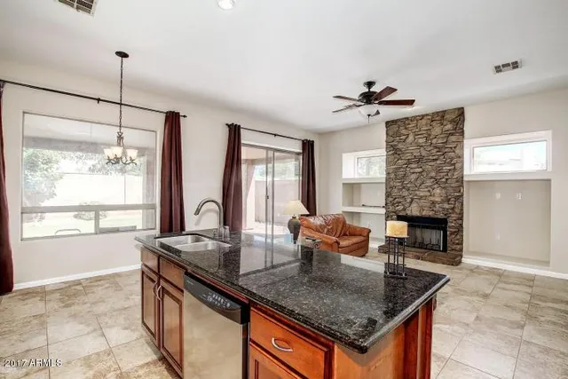 a kitchen with granite countertop a stove and a sink