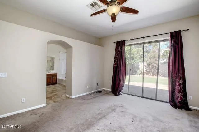 an empty room with windows and closet