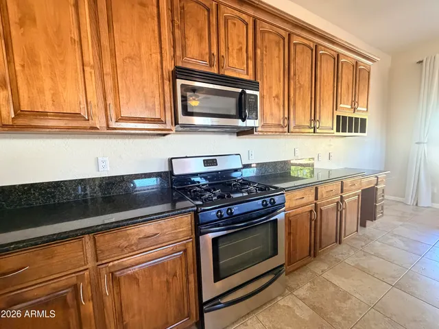 a view of a house with a yard and sitting area