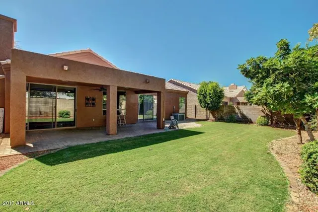 a view of a house with backyard porch and garden