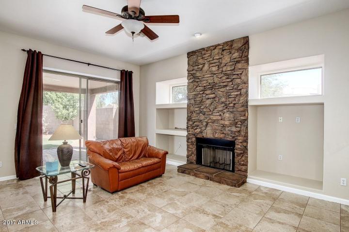 16810 North 62nd Place Scottsdale, AZ 85254 - Photo 5 of 31 a living room with furniture a fireplace and a window