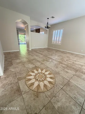a view of an empty room with a fireplace and a window