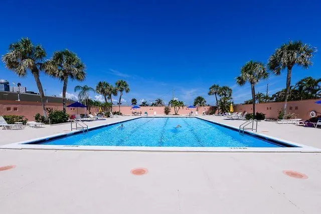a view of swimming pool and outdoor seating