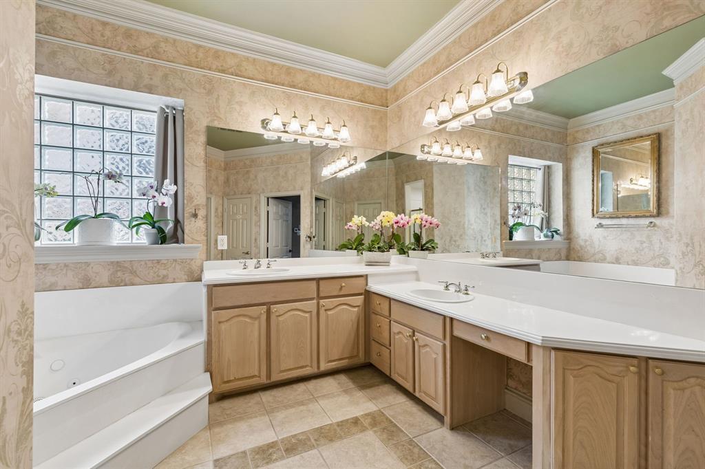8517 Navigation Drive Rowlett, TX 75088 - Photo 23 of 39 a spacious bathroom with a granite countertop sink a large mirror and a bathtub