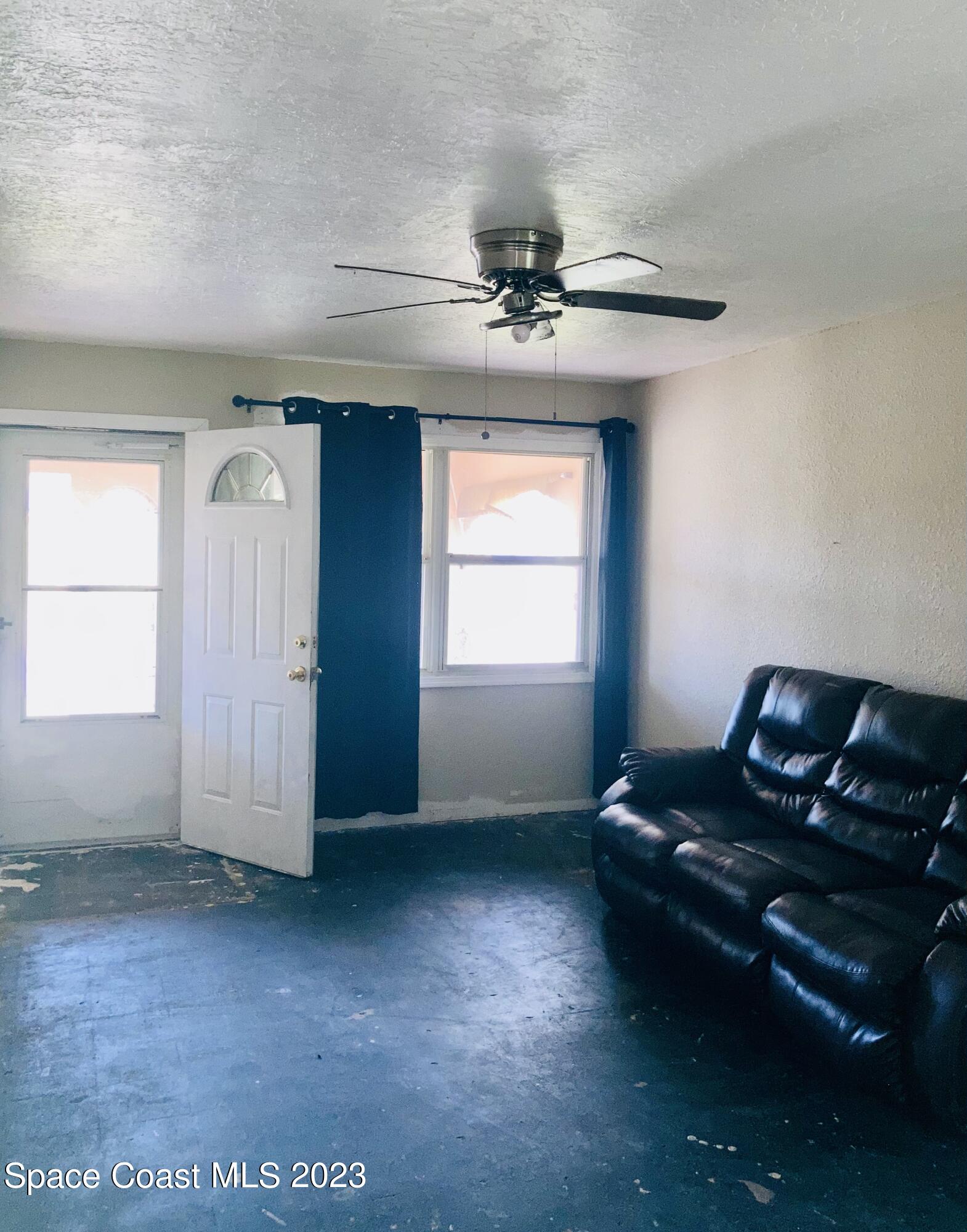 4396 Doncaster Drive Melbourne, FL 32935 - Photo 12 of 22 a living room with furniture and a window