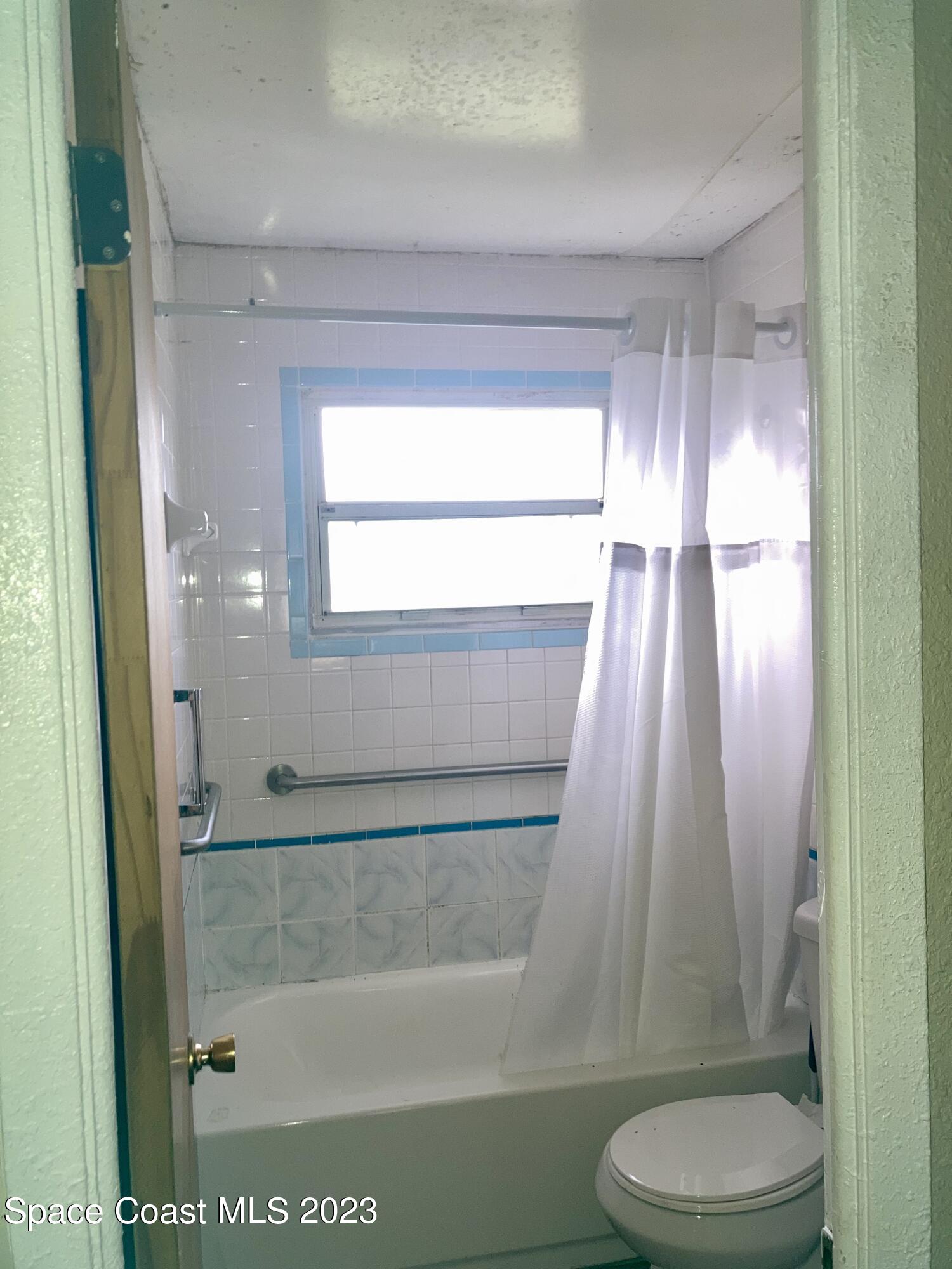 4396 Doncaster Drive Melbourne, FL 32935 - Photo 13 of 22 a bathroom with a toilet and a shower