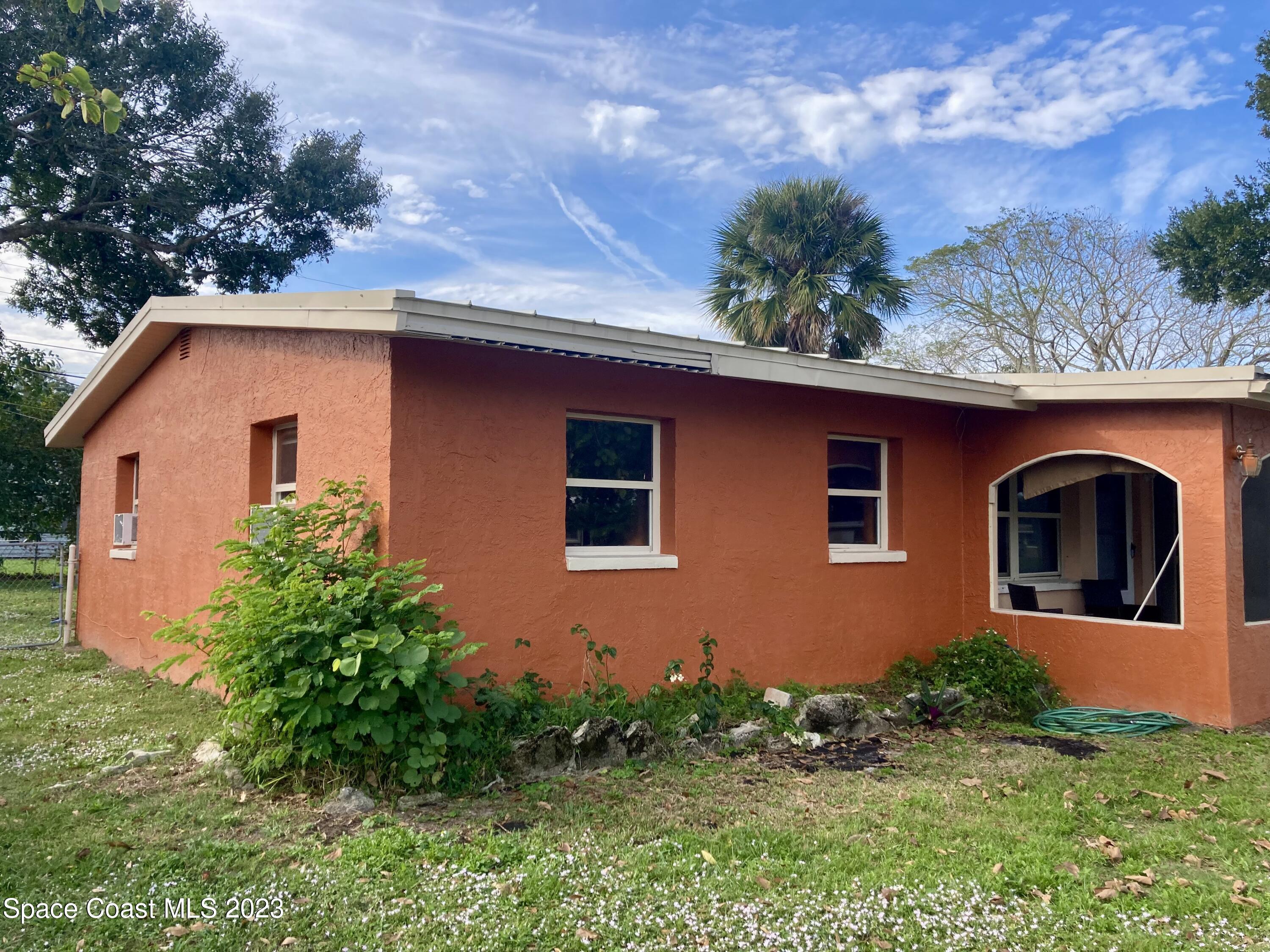 4396 Doncaster Drive Melbourne, FL 32935 - Photo 5 of 22 a front view of a house with garden
