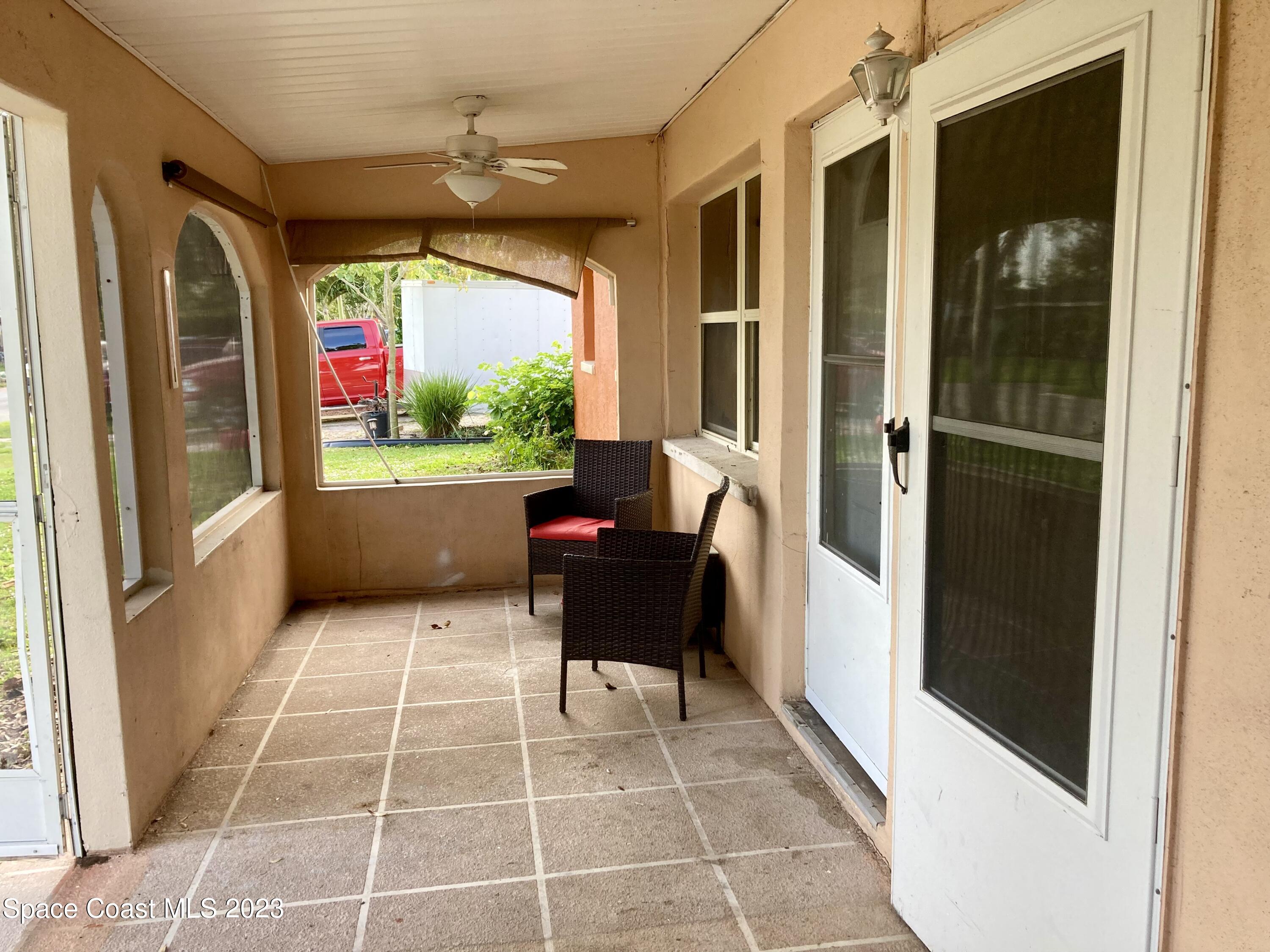 4396 Doncaster Drive Melbourne, FL 32935 - Photo 6 of 22 a living room with furniture and a large window