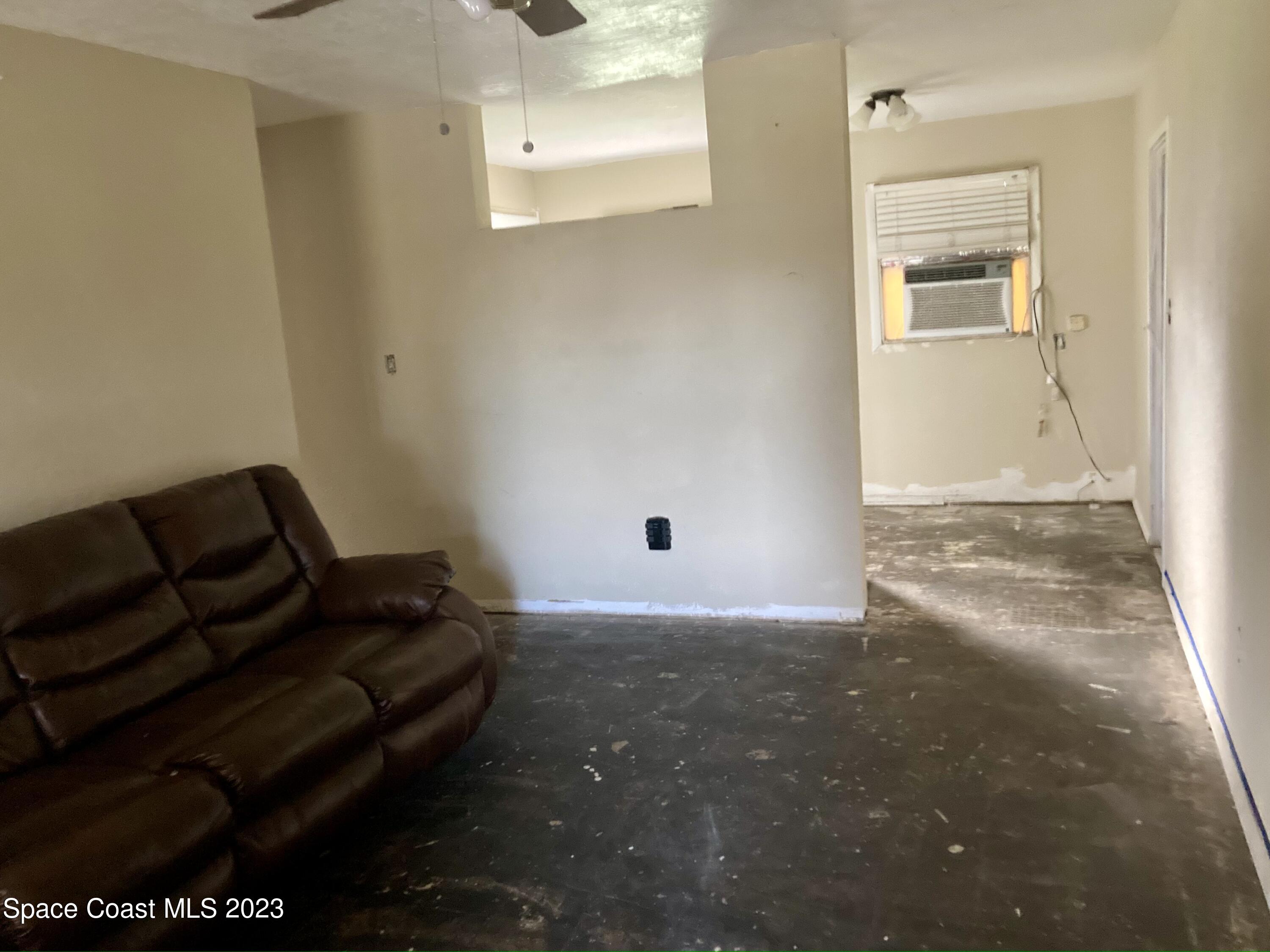 4396 Doncaster Drive Melbourne, FL 32935 - Photo 8 of 22 a living room with furniture and a window