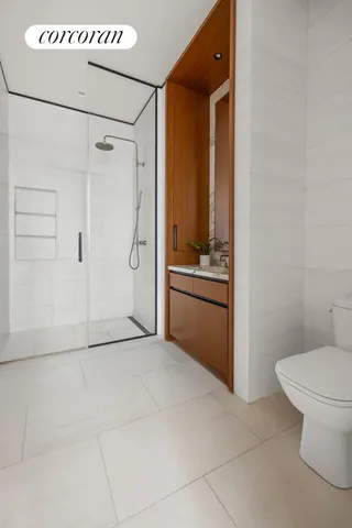 a bedroom with a bed and a potted plant