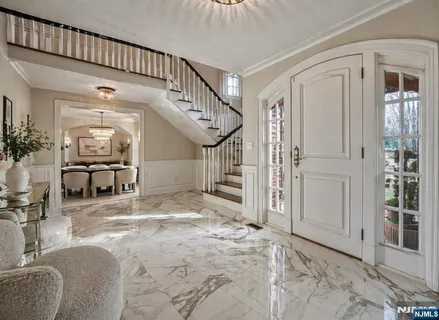 a spacious bedroom with a large bed and a chandelier