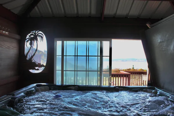 a kitchen with stainless steel appliances a dining table chairs refrigerator and sink