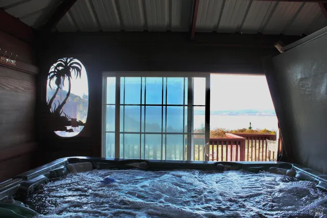 a kitchen with stainless steel appliances a dining table chairs refrigerator and sink