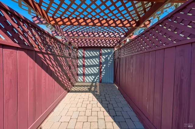 a kitchen with stainless steel appliances granite countertop a refrigerator a sink dishwasher a stove and white countertops with wooden floor