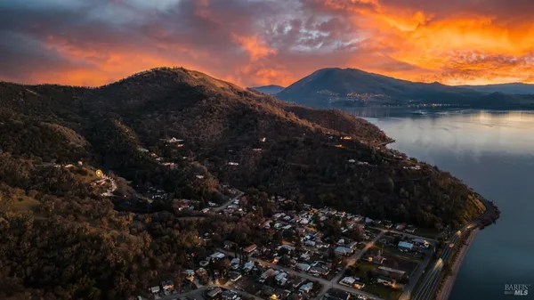 a view of a house with a small yard and potted plants